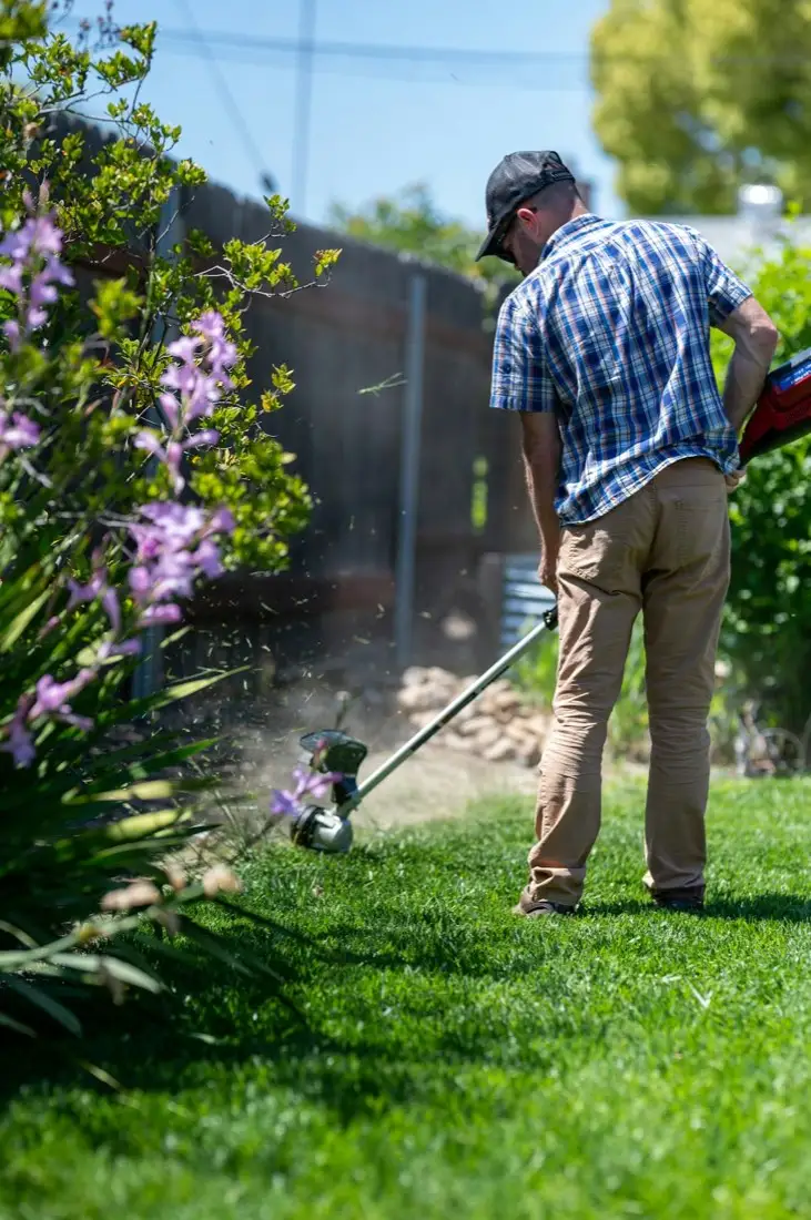 Edging a lawn along a flowerbed in Carson, CA